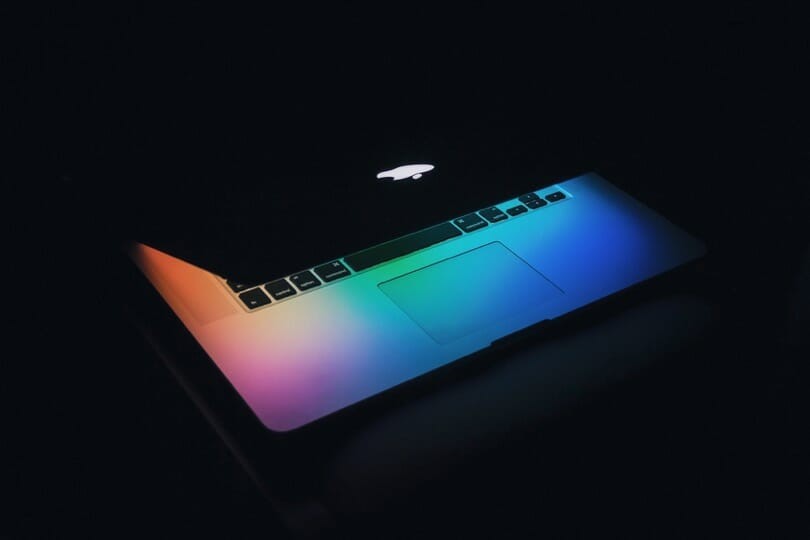 Apple computer with rainbow colors with a dark background